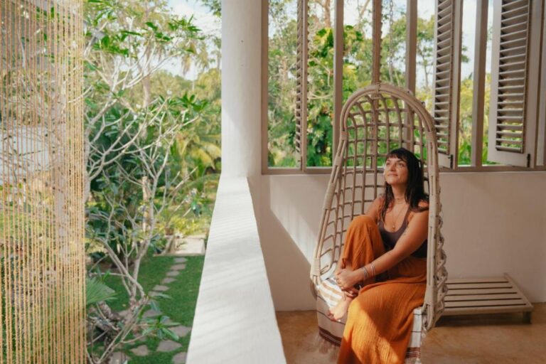 A woman seated on a chair by a window at Kirinuga Boutique Retreat in Tangalle, enjoying the serene view.