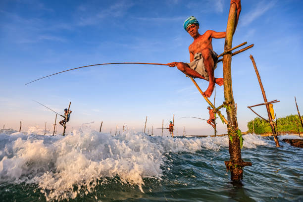 Fishermen casting their rods into the sea, engaged in the art of fishing amidst the tranquil waters