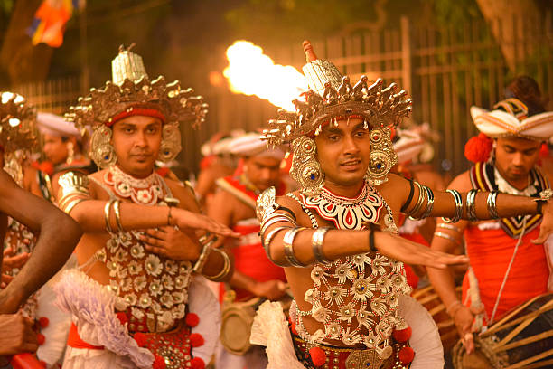 A group of men in traditional Kandy costumes and headdresses, showcasing cultural heritage and vibrant attire.