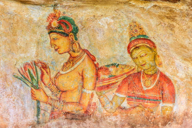 Ancient painting depicting two women on a rock wall, showcasing historical artistry and cultural significance.