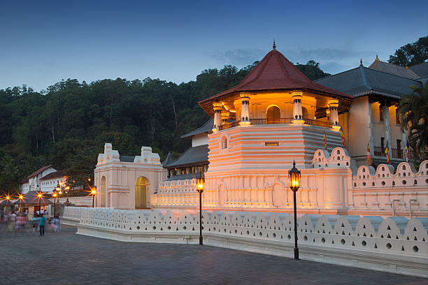 A white structure topped with a vibrant red roof, standing out prominently in its surroundings.